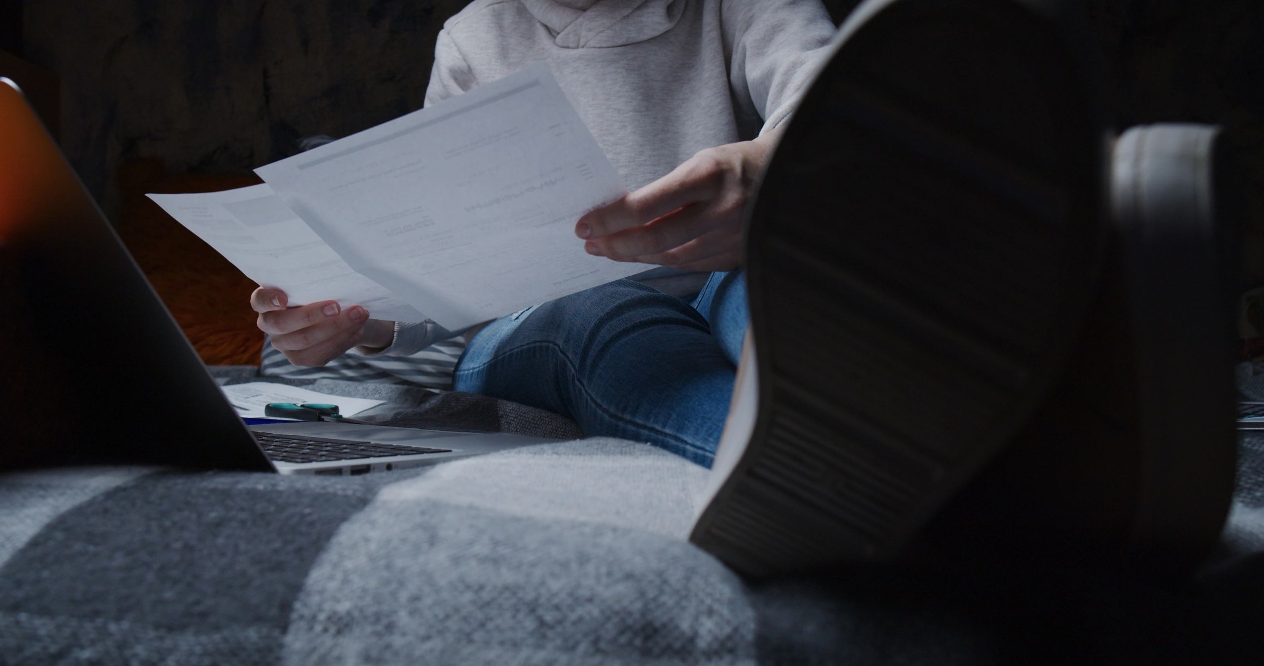Person reviewing car finance paperwork before selling a vehicle